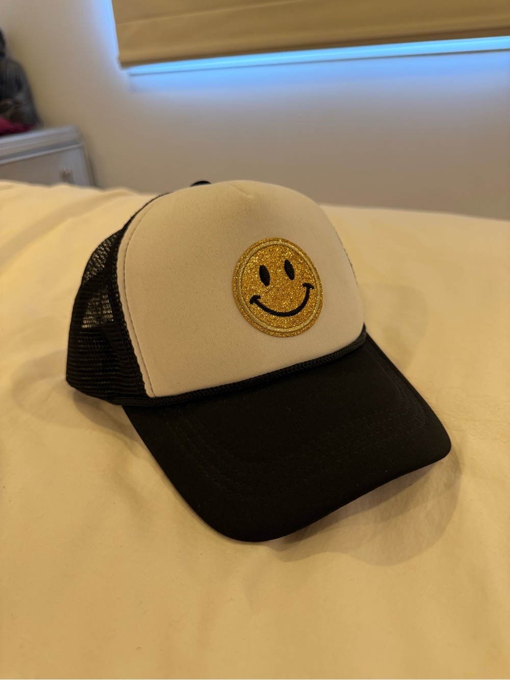 Black & White Trucker Hat with Gold Smiley Patch